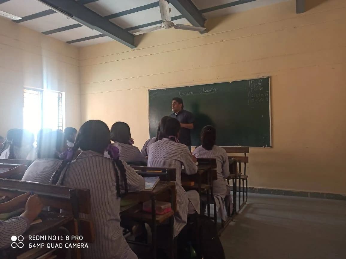 A facilitator leading a career planning session with students, with 'Career Planning' written on the blackboard.
